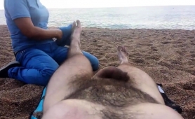 Lucky Guy Has A Sexy Lady Massaging His Feet On The Beach