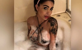 tattooed-brunette-showing-off-her-big-boobs-in-the-bathtub