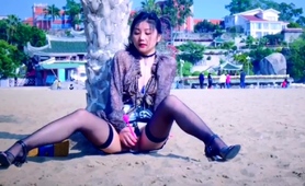Asian Cutie In Stockings Gets Herself Off On The Beach