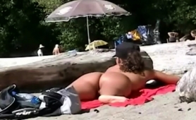 nudist-beach-voyeur-finds-a-sexy-brunette-with-a-perfect-ass